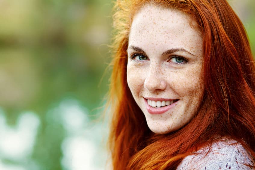 Red hair woman with freckles on her face