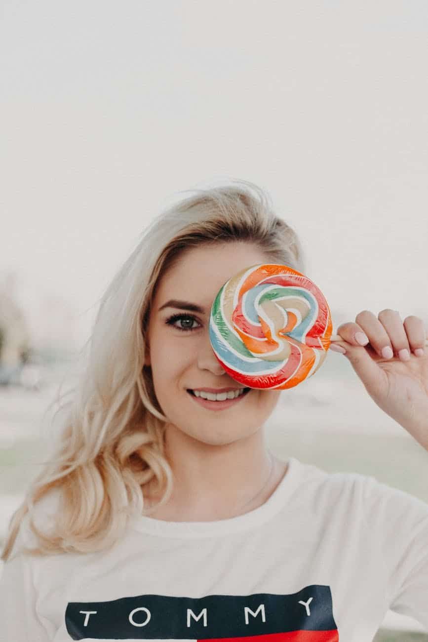 Blonde hair woman with candy in her left eye