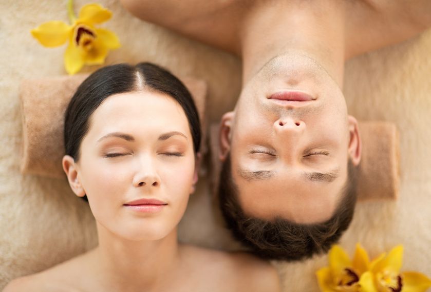 Picture of couple in spa salon lying on the massage desks