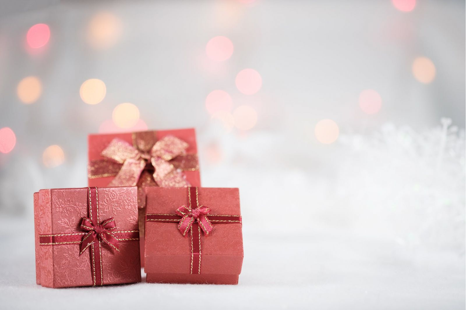 Photo of three small red gift boxes against a blurry background