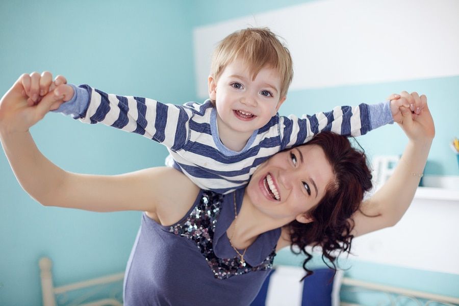 Young mother playing with her toddler son