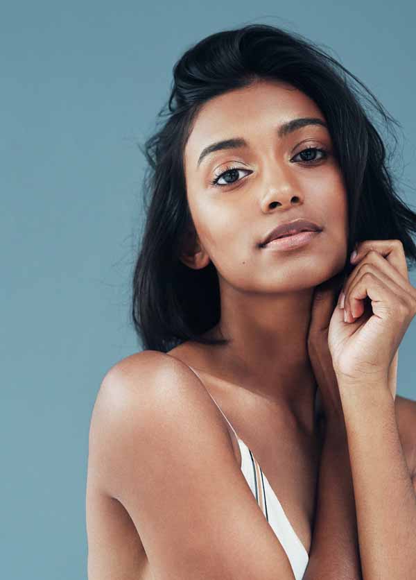 Shot of a beautiful young woman posing against a blue background