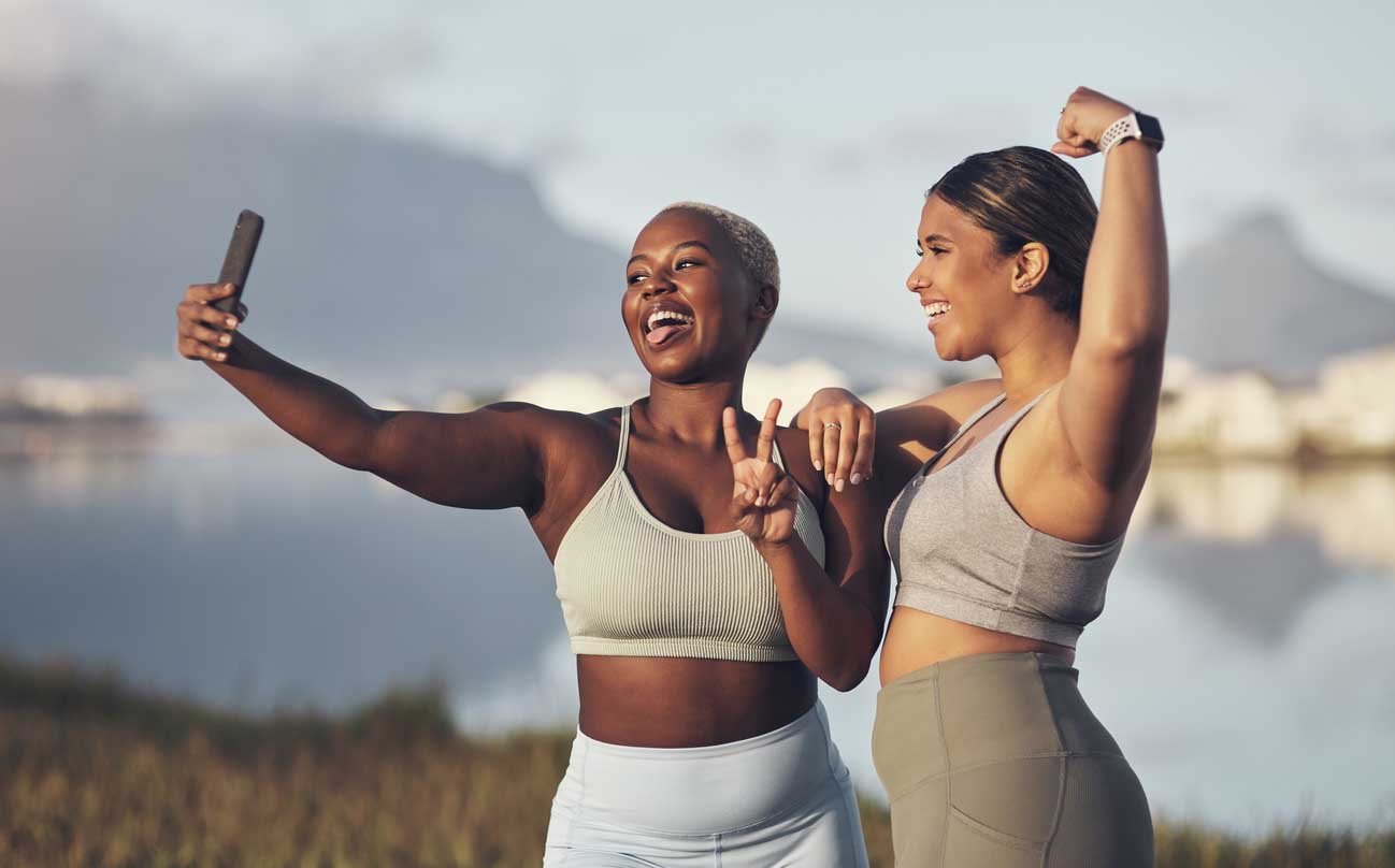 Shot of two women taking a selfie while out for a run together Shot of two women taking a selfie while out for a run together