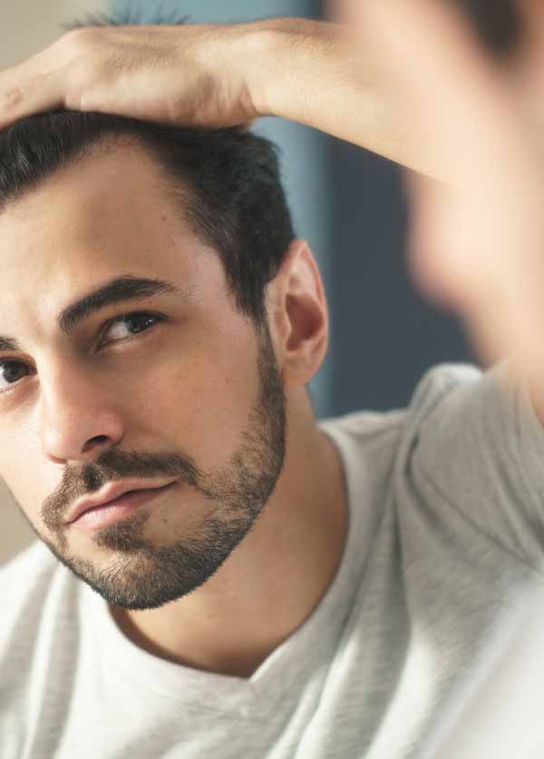 Man Worried For Alopecia Checking Hair For Loss