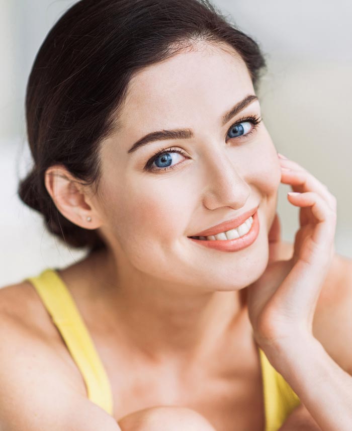 Young woman receiving local laser skin tightening on her face